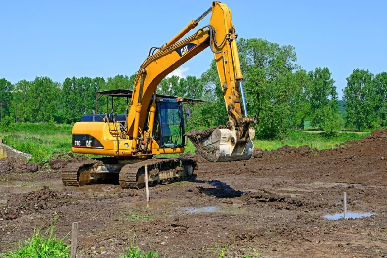 Excavation Service A yellow excavator is working to excavate dirt at a construction area.