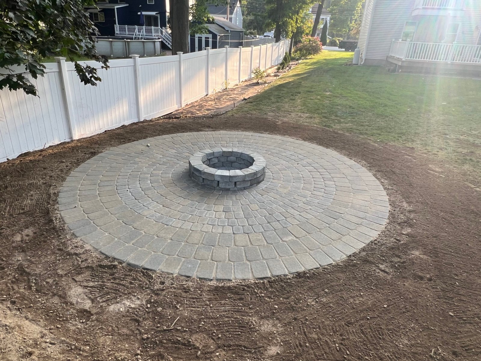 A vibrant flower garden blooms in front of a charming house, showcasing a variety of colorful blossoms and greenery.